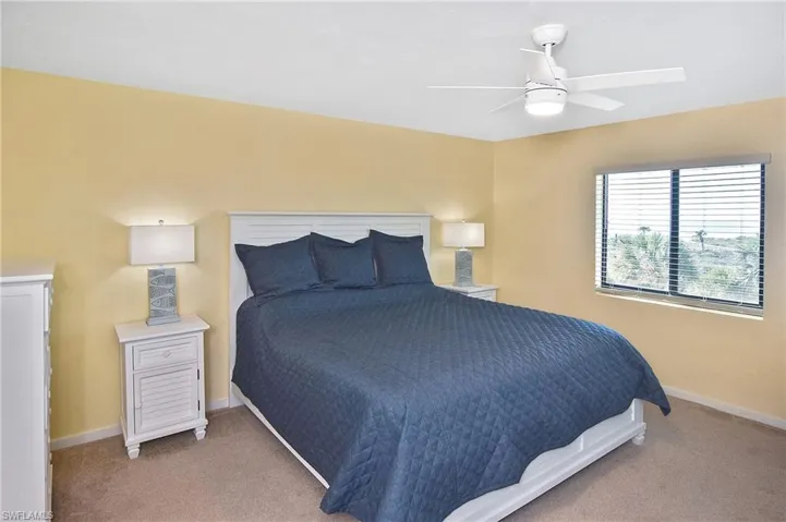 Bedroom featuring a ceiling fan and carpet flooring