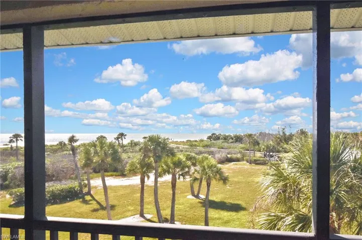 Balcony with view of water and beach