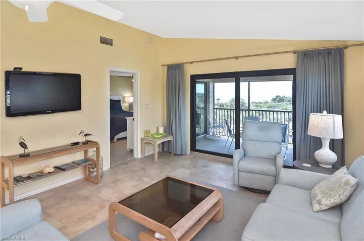 Living area with vaulted ceiling and baseboards