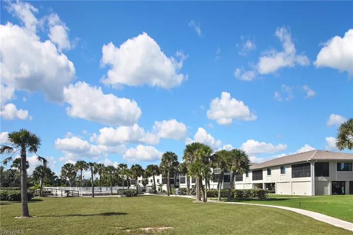 View of home's community with a lawn