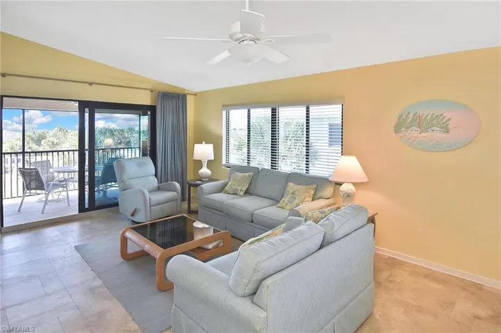 Living area featuring vaulted ceiling and a ceiling fan