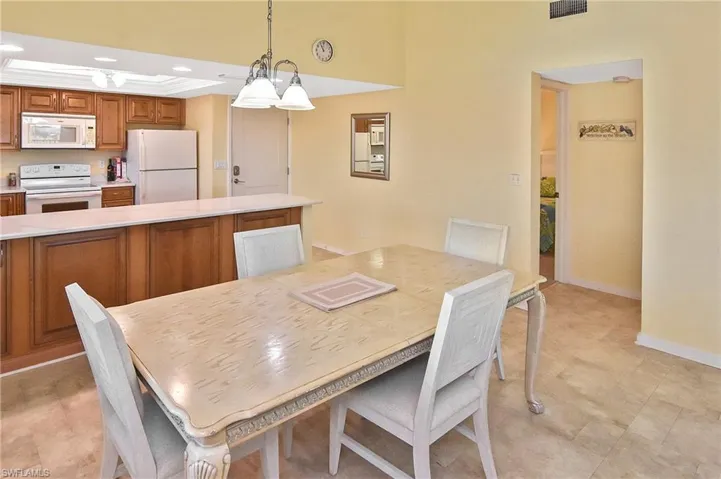 Dining room featuring recessed lighting and a raised ceiling