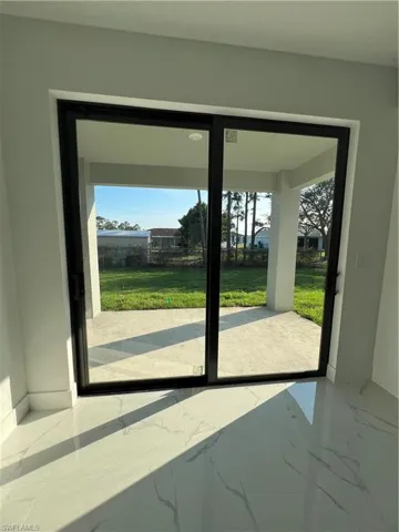 Doorway featuring marble finish floor and baseboards