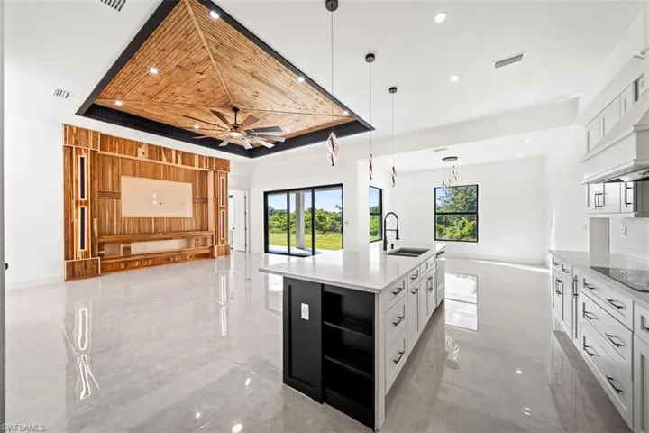 Vaulted wood-paneled ceiling with recessed lighting and ceiling fan