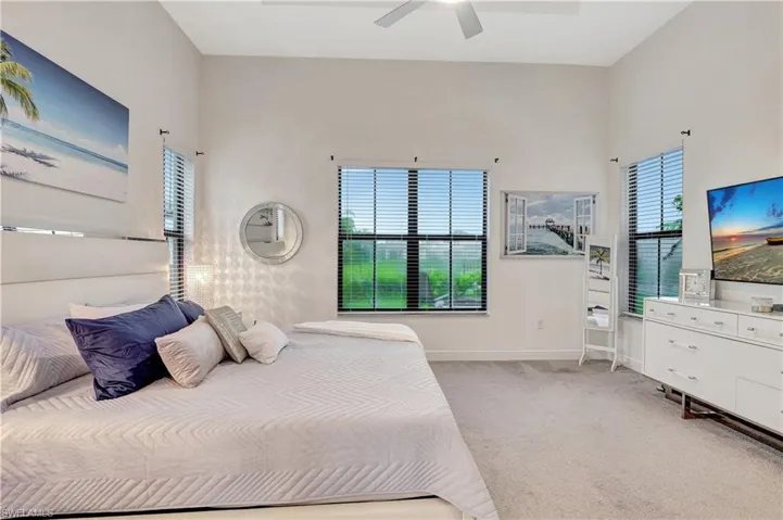 Bedroom with light carpet and ceiling fan