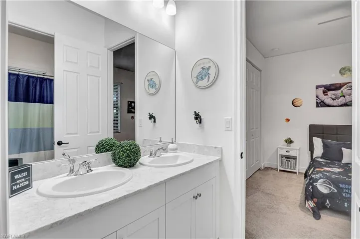 Jack & Jill Bathroom shared by bedroom 3&4 with double vanity and shower/tub combo
