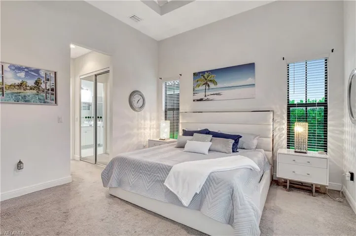 Bedroom featuring a closet, carpet flooring, and multiple windows
