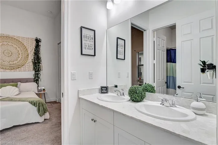 Jack & Jill Bathroom shared by bedroom 3&4 with double vanity and shower/tub combo