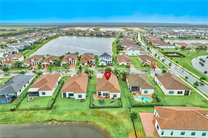 Birds eye view of property with a water view