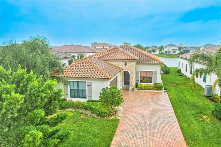 Mediterranean / spanish-style house with a front yard and central AC