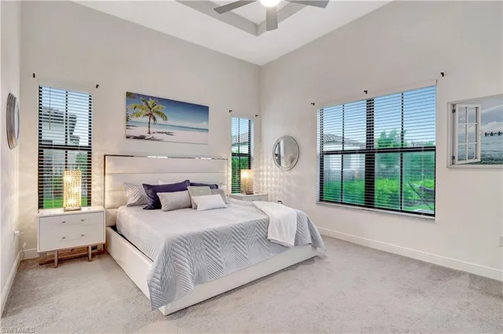 Expansive Primary Bedroom featuring vaulted tray ceilings, ensuite and 2 walk in closets