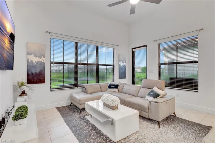 Tiled living room featuring ceiling fan