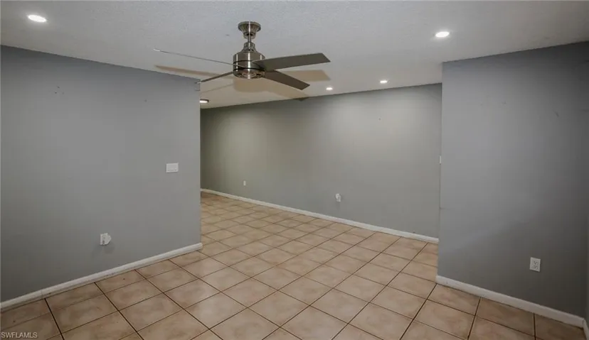 Tile flooring throughout, recessed ceiling lighting, and a ceiling fan with brushed nickel finish
