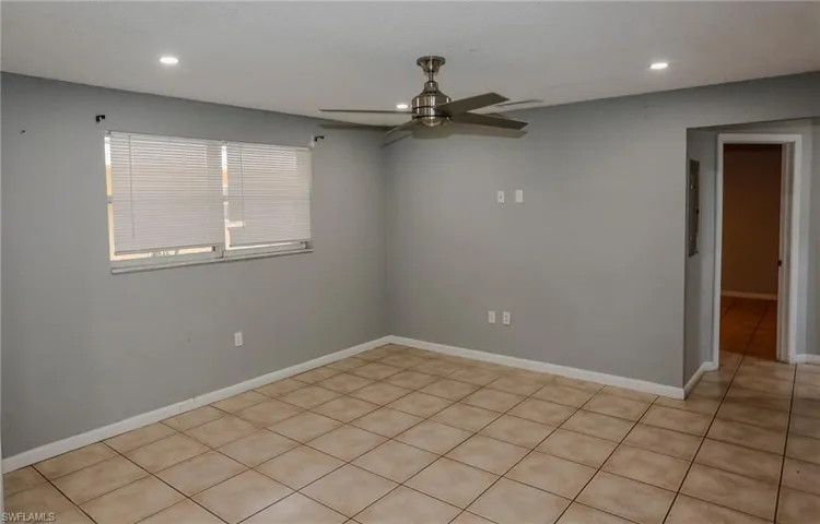 Recessed ceiling lighting, a ceiling fan with brushed nickel accents, ceramic tile flooring, and a window with horizontal blinds