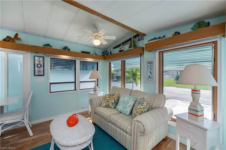 Living area with ceiling fan and wood finished floors