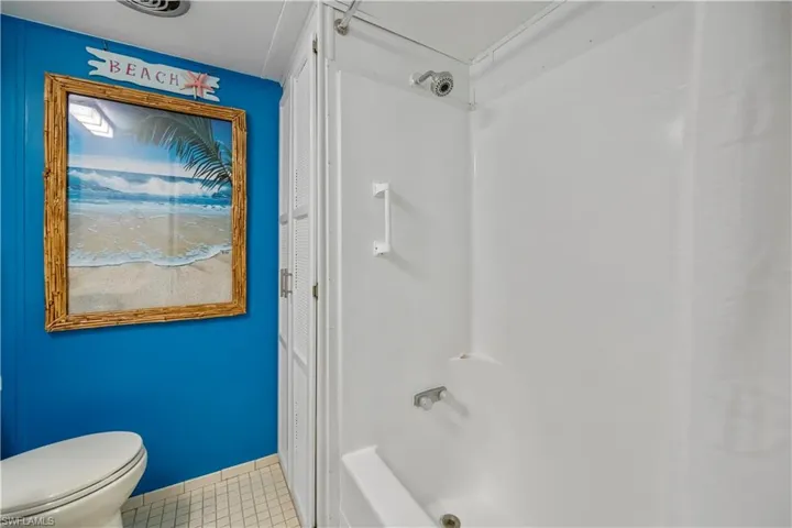Full bathroom featuring tile patterned floors and bathtub / shower combination