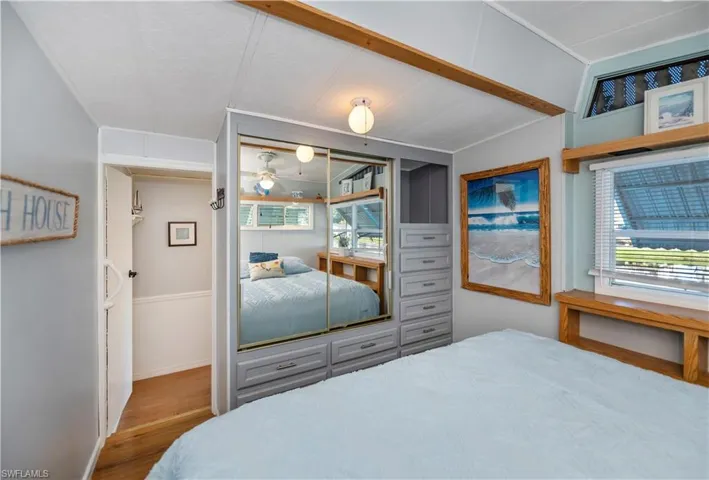 Bedroom featuring wood finished floors and baseboards