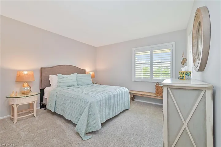 Bedroom featuring baseboards and light colored carpet