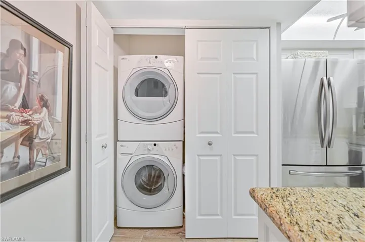 Washroom with laundry area and stacked washer / dryer