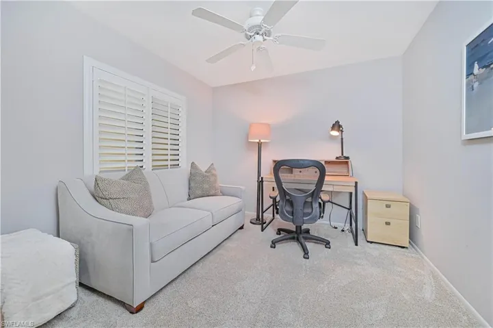 Home office with baseboards, a ceiling fan, and carpet
