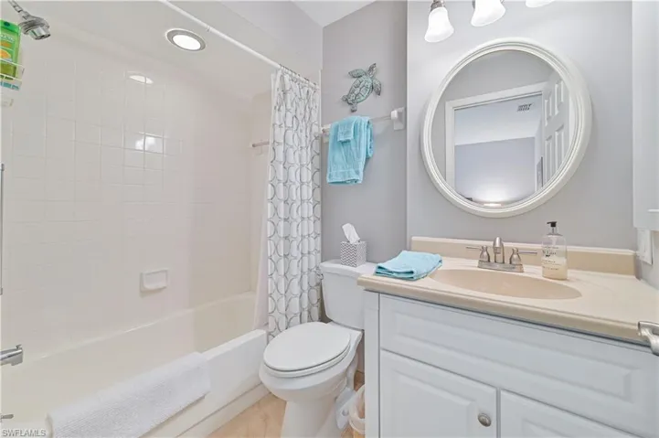 Bathroom featuring vanity, toilet, visible vents, and shower / bath combo