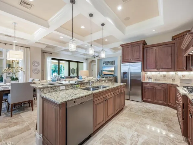 Kitchen featuring gas range and stainless steel appliances with island seating