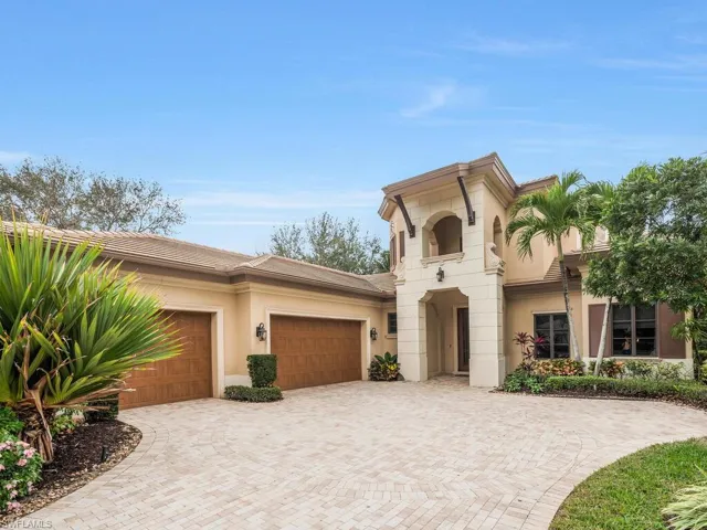 View of front facade with decorative driveway, a 3 car attached garage