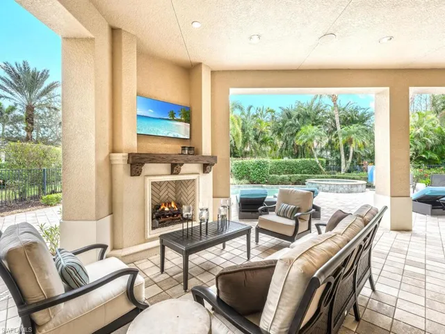 Outdoor gas fireplace overlooking the pool
