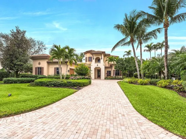 Mediterranean house in Naples, FL for sale with a front lawn and stucco siding