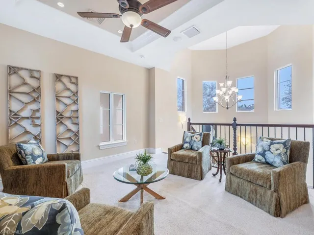 Loft/family room with volume ceiling, overlooking a chandelier