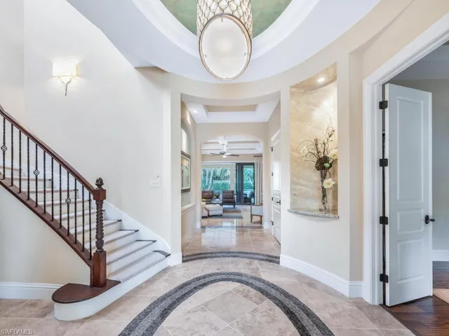 Grand foyer entrance with mosaic tiled floor, art niches and volume ceilings