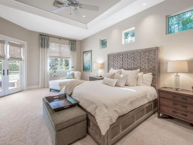 Primary Bedroom with a tray ceiling, access to the pool, recessed lighting