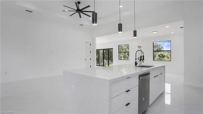 Kitchen with modern cabinets, white cabinetry, dishwasher, recessed lighting, and open floor plan