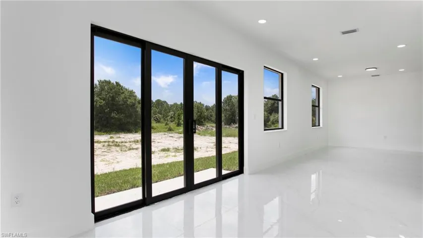 Spare room with light marble finish flooring and recessed lighting