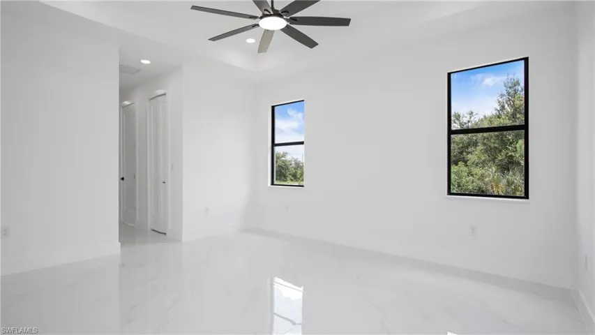Empty room featuring recessed lighting, marble tiled floors, and ceiling fan