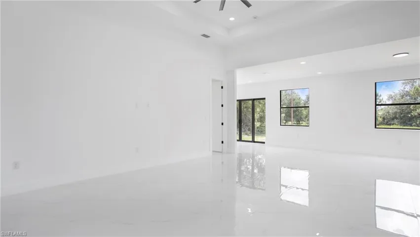 Unfurnished room with light marble finish floors, a ceiling fan, and recessed lighting