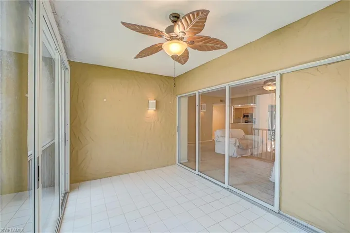 Unfurnished sunroom featuring ceiling fan