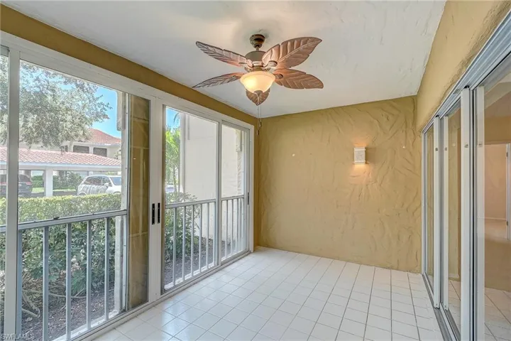 Unfurnished sunroom featuring ceiling fan