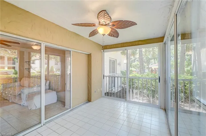 Unfurnished sunroom featuring ceiling fan