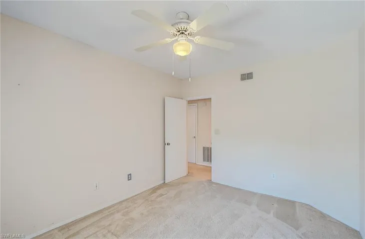 Spare room with light colored carpet and ceiling fan