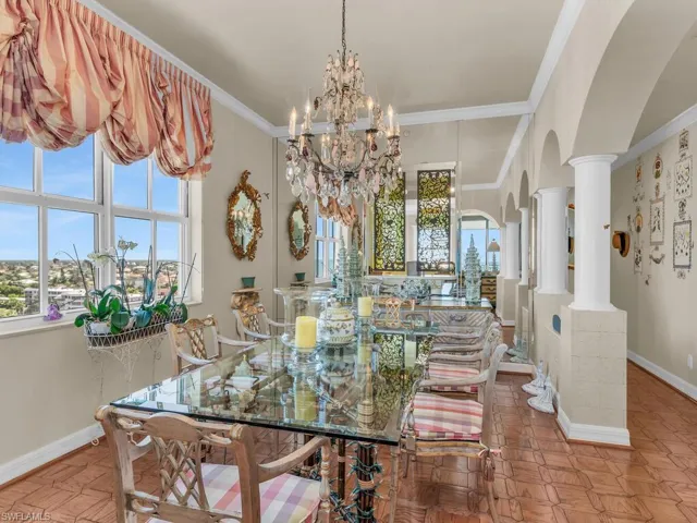 Dining area featuring plenty of natural light, ornamental molding, and light parquet flooring