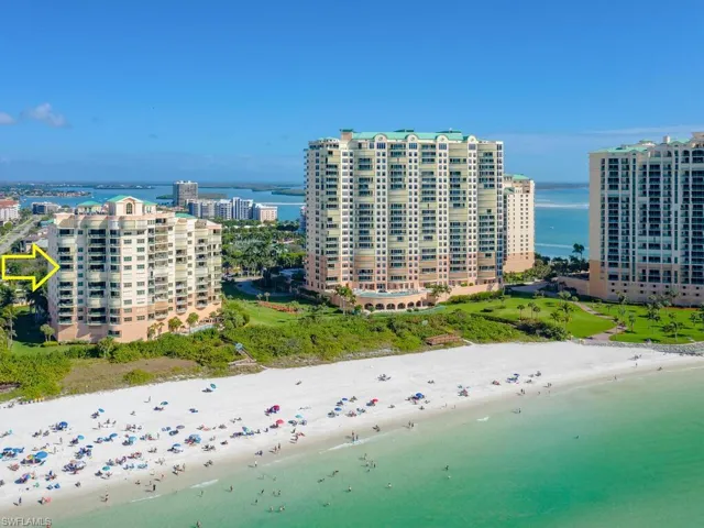 Aerial view featuring a beach view and a water view