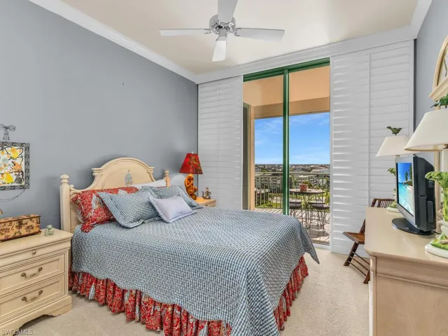 Carpeted bedroom with crown molding, ceiling fan, and access to exterior