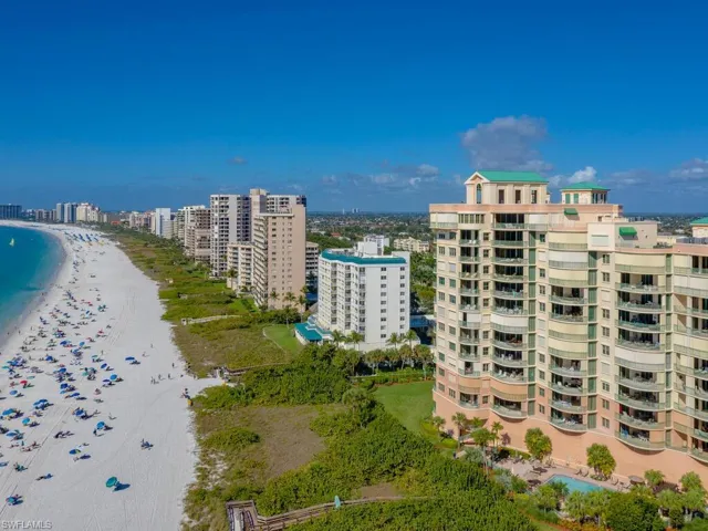 View of property with a view of the beach and a water view