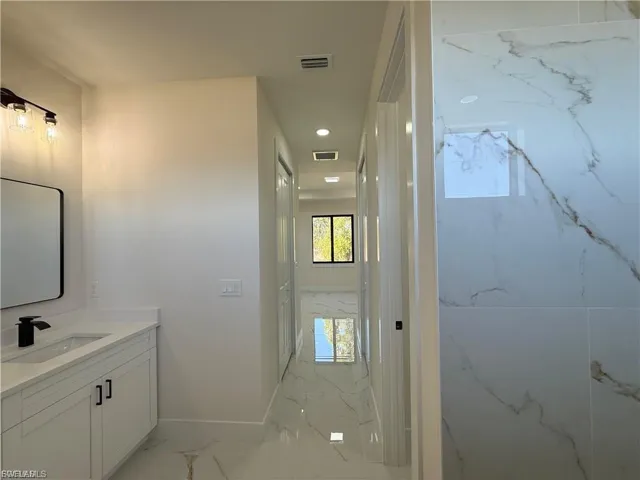 Bathroom featuring vanity and recessed lighting