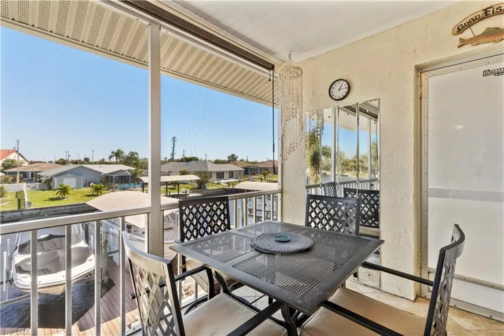 Balcony / lanai, screened in overlooking canal and back door to back stairwell.