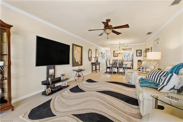 Looking in from Lanai to living room, dining area, kitchen and front entrance.