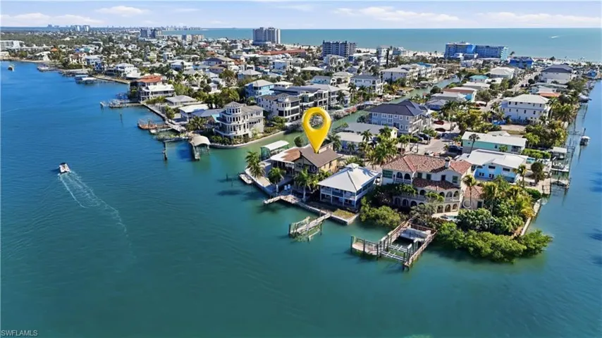 Aerial view of property's location featuring a large body of water and nearby urban area - Virtually Edited Image