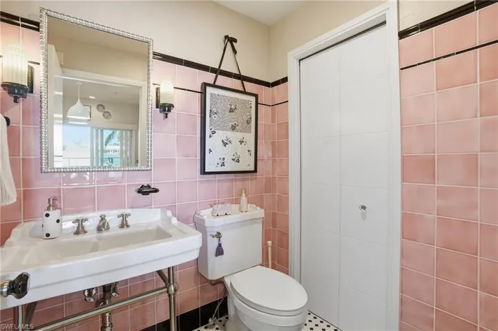 Bathroom featuring toilet and tile walls - Virtually Edited Image