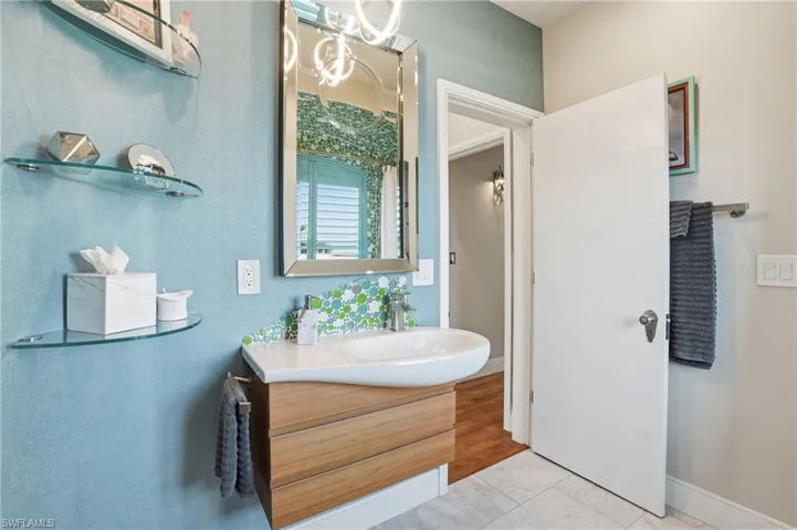 Bathroom featuring vanity and baseboards - Virtually Edited Image